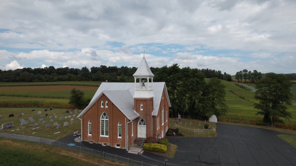 Snapshot of Word and Deed teaser drone shot of church